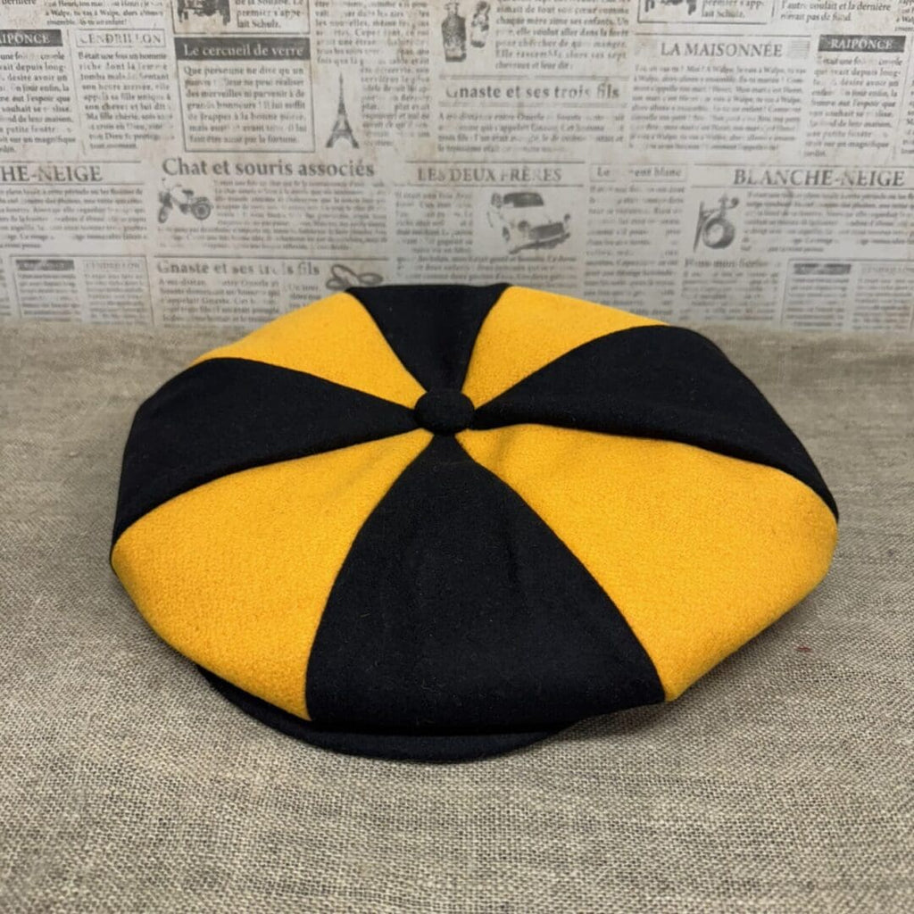 Black and gold eight-panel newsboy cap.