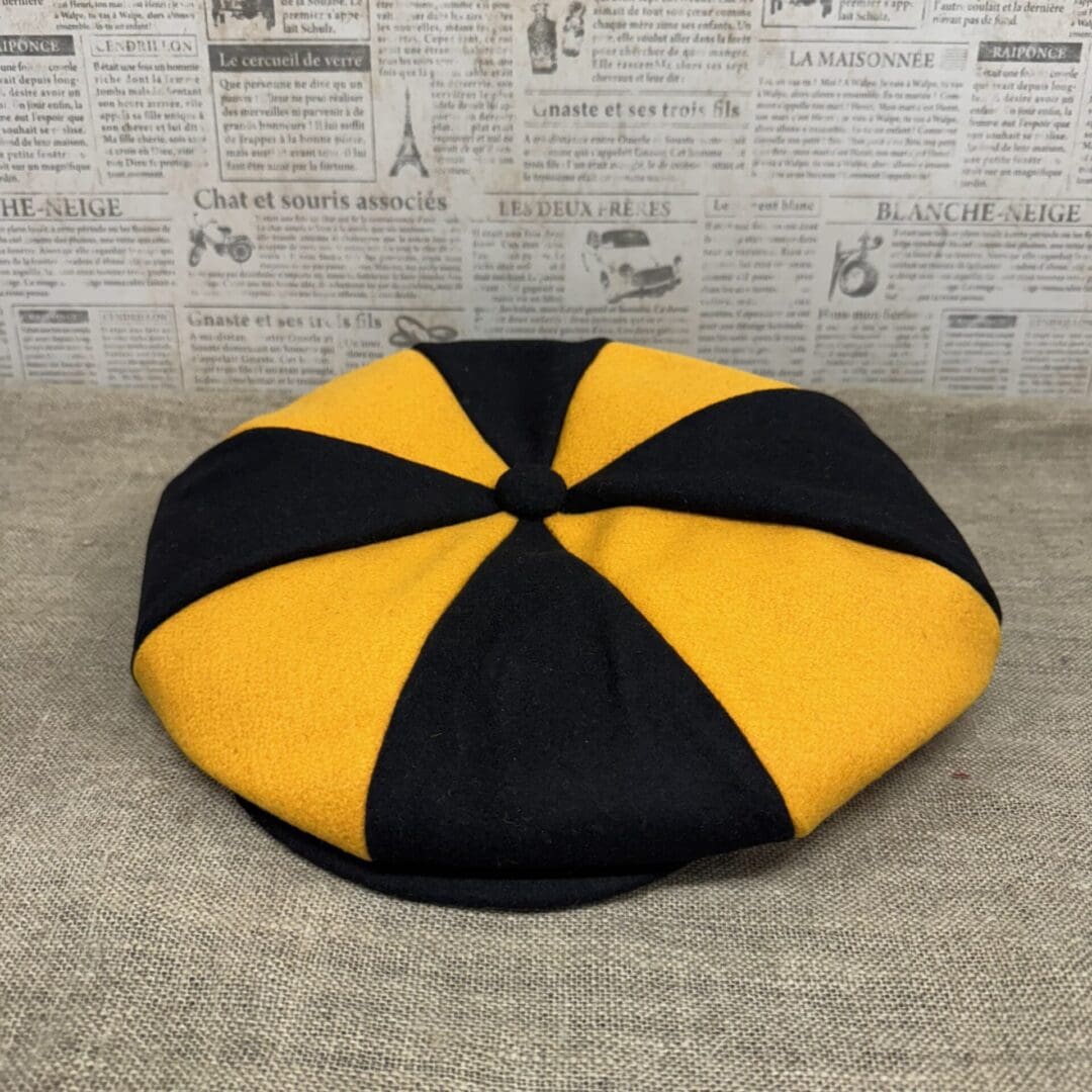 Black and gold eight-panel newsboy cap.