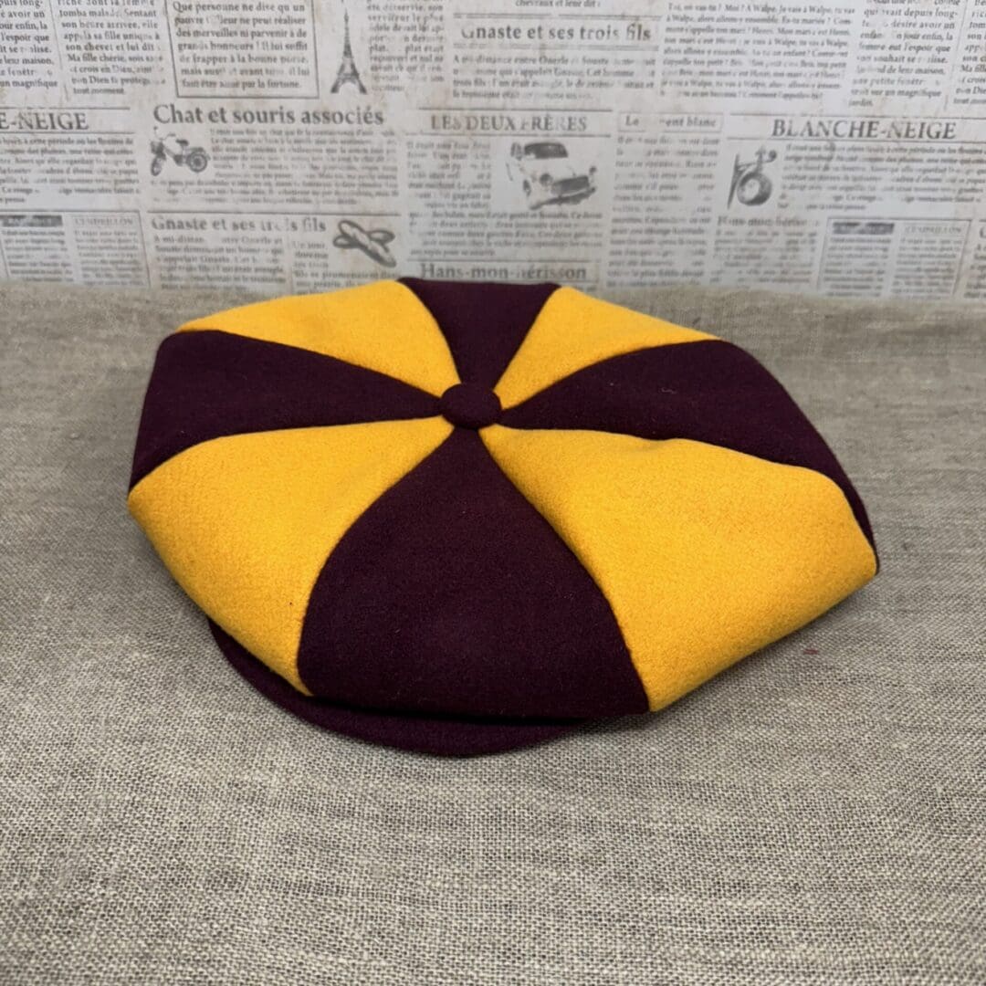 Mustard and maroon eight-panel flat cap.