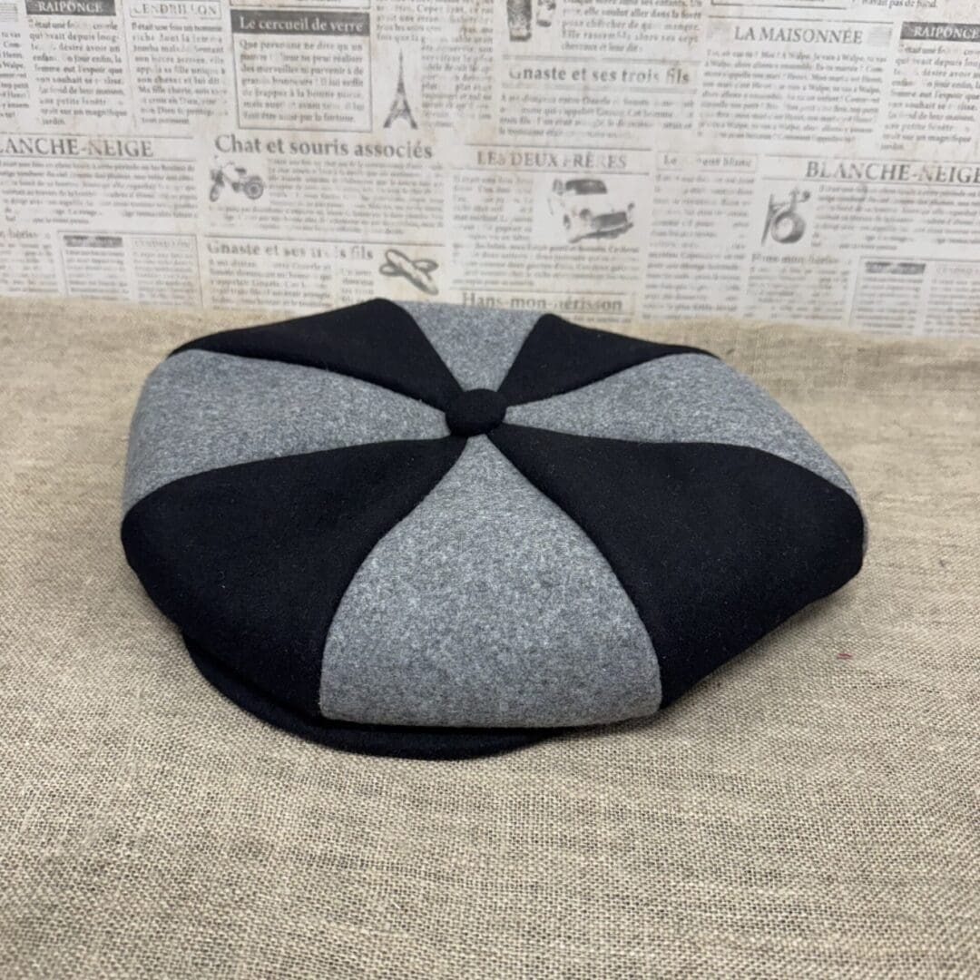 Gray and black eight-panel newsboy cap.