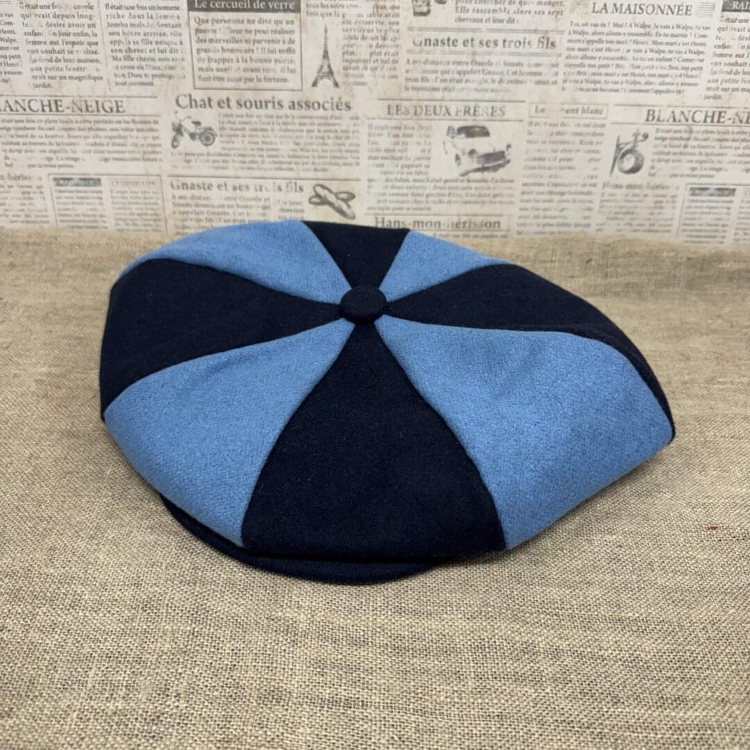 Blue and black eight-panel flat cap.