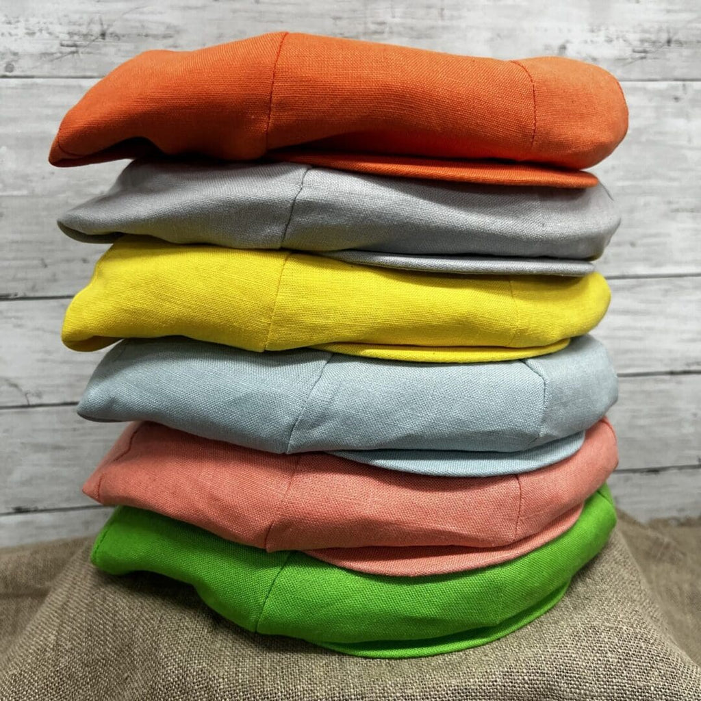 A stack of different colored pillows on top of each other.