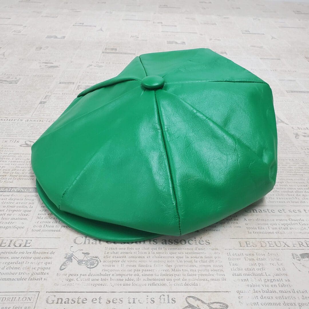 A green hat sitting on top of the floor.