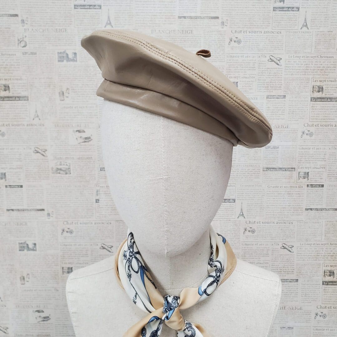 A mannequin wearing a hat and neck tie.