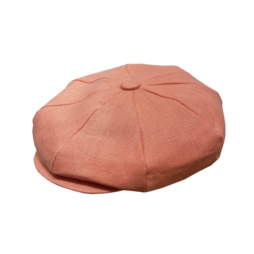 A pink hat is sitting on the ground.