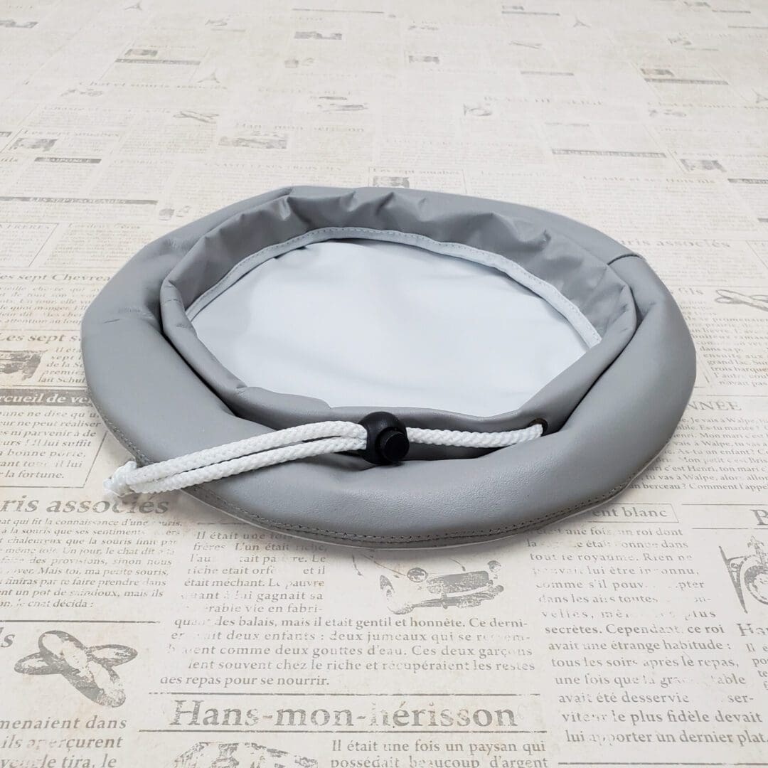 A gray frisbee on top of a table.