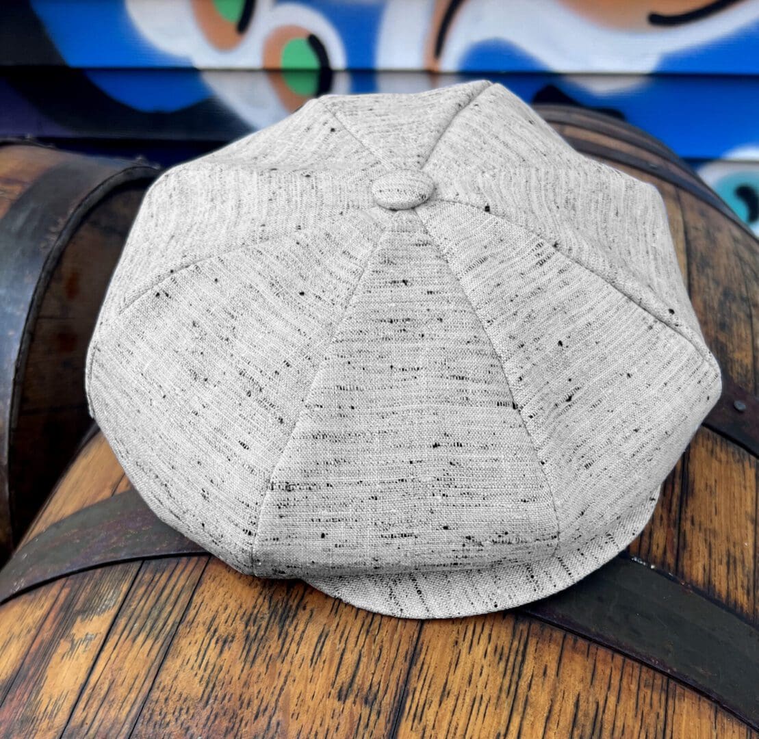 A hat is sitting on top of a barrel.