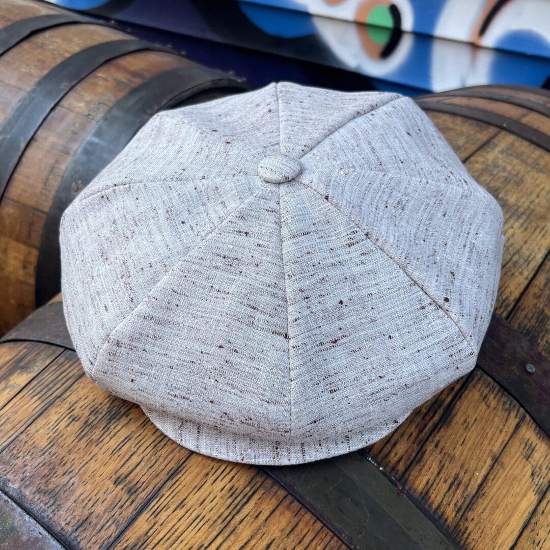 A hat sitting on top of some barrels.