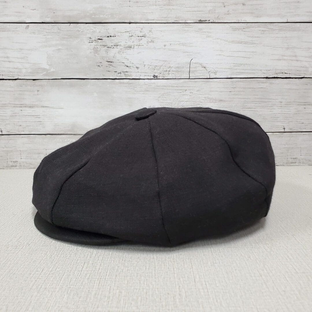 A black hat sitting on top of a table.