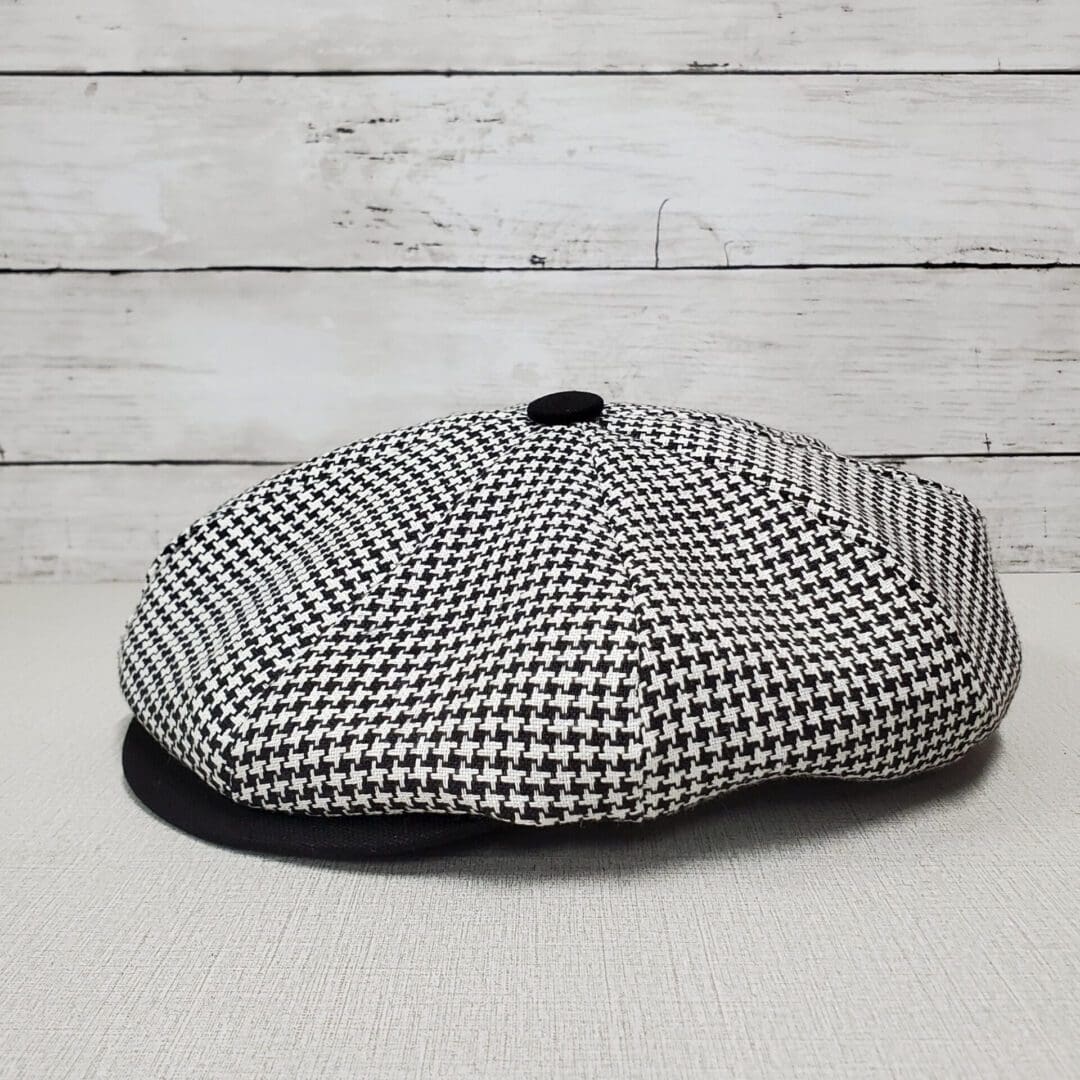A black and white hat sitting on top of a table.