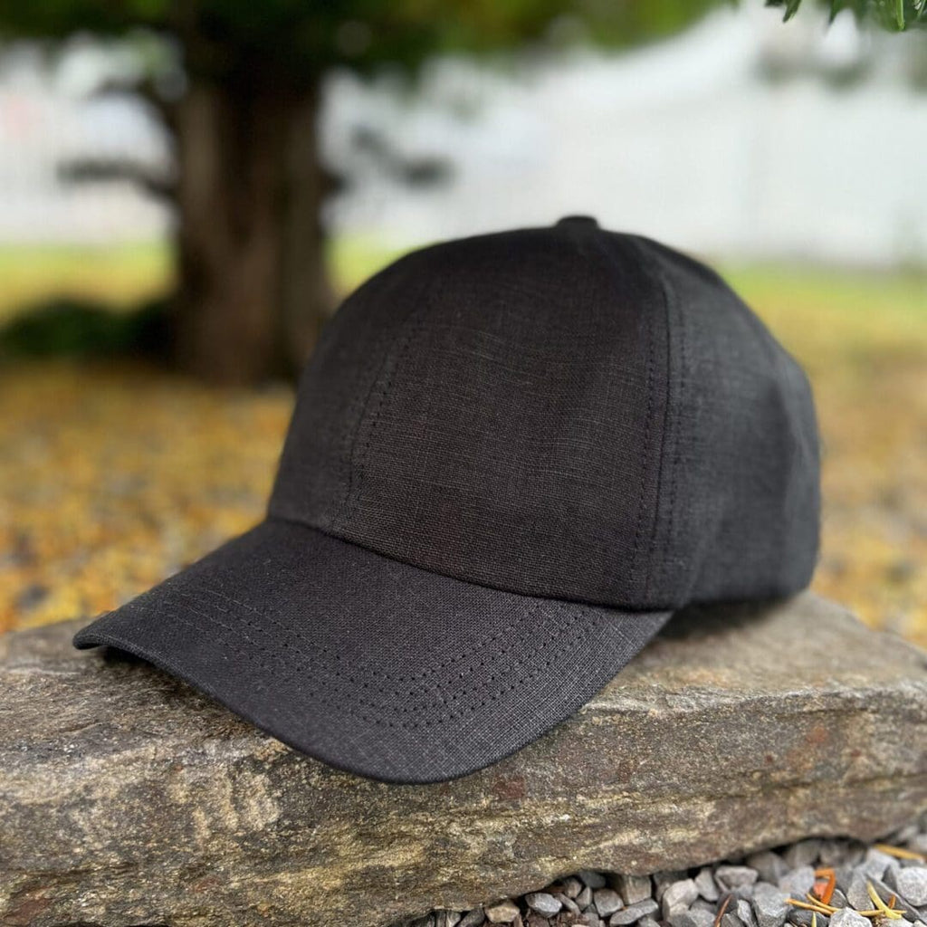A black hat sitting on top of a rock.