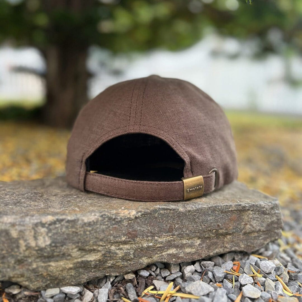 A brown hat sitting on top of a rock.