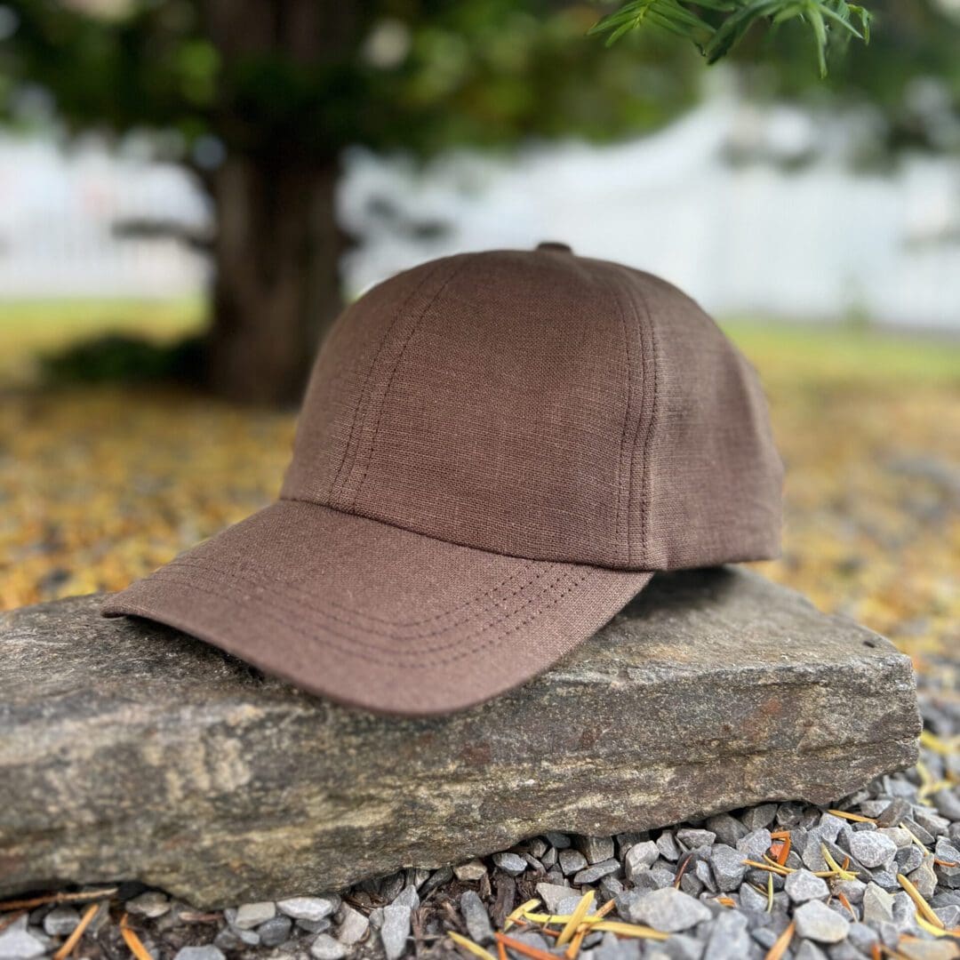 A brown hat sitting on top of a rock.