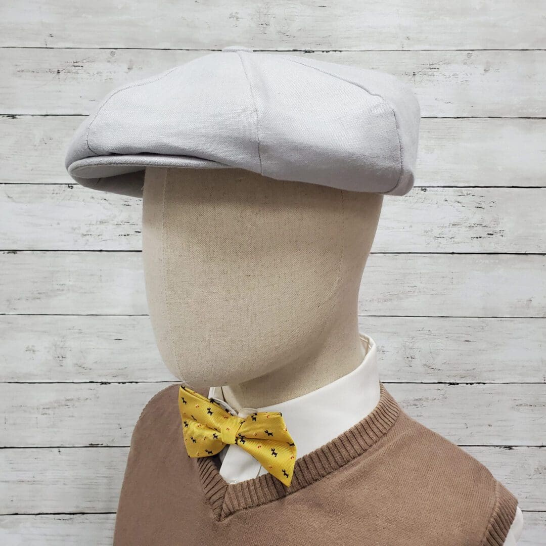 A man wearing a bow tie and hat