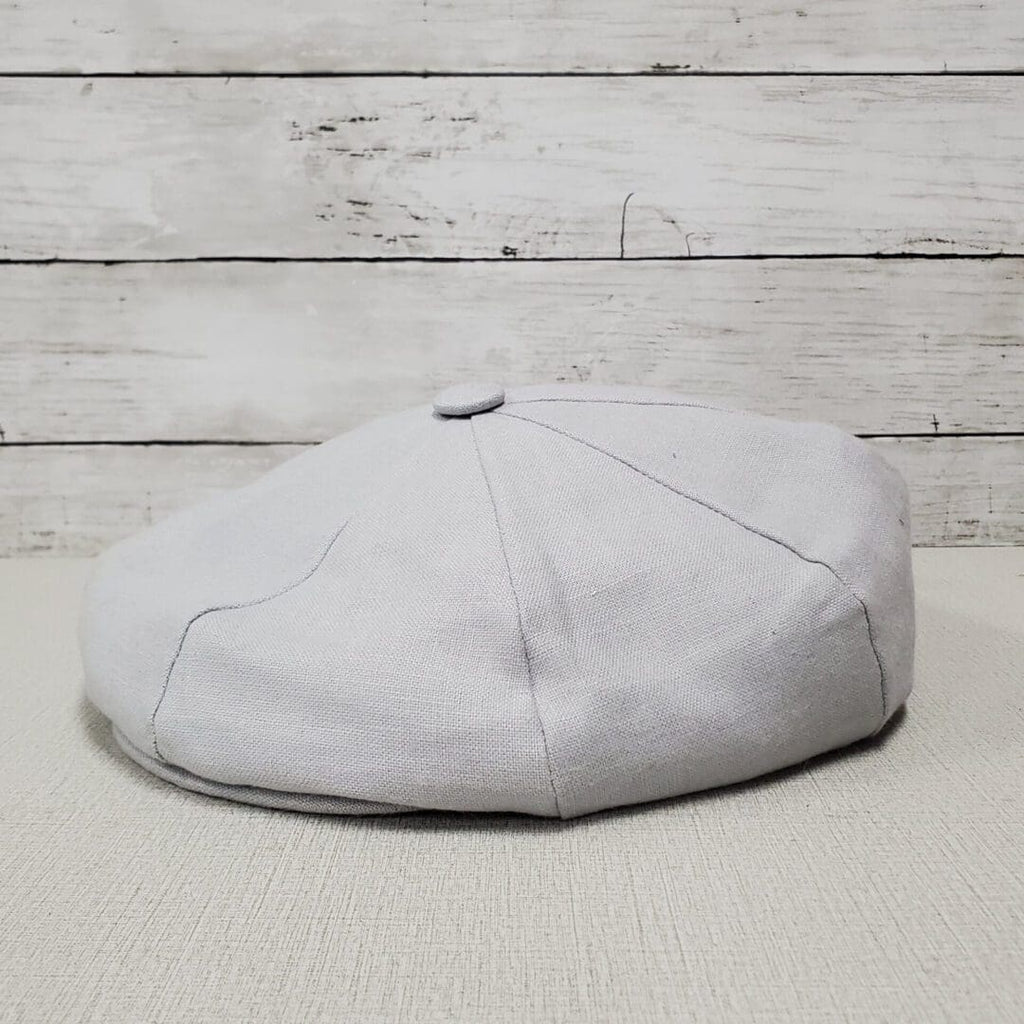 A white hat sitting on top of the floor.