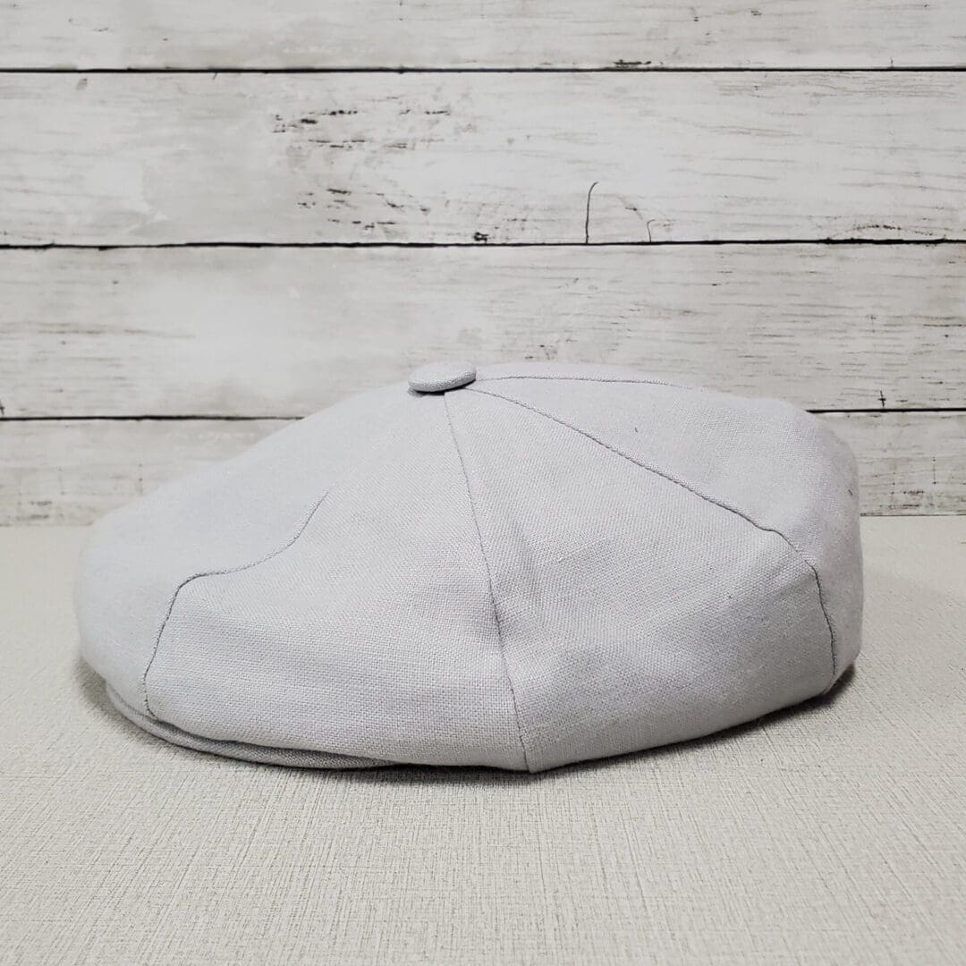 A white hat sitting on top of the floor.