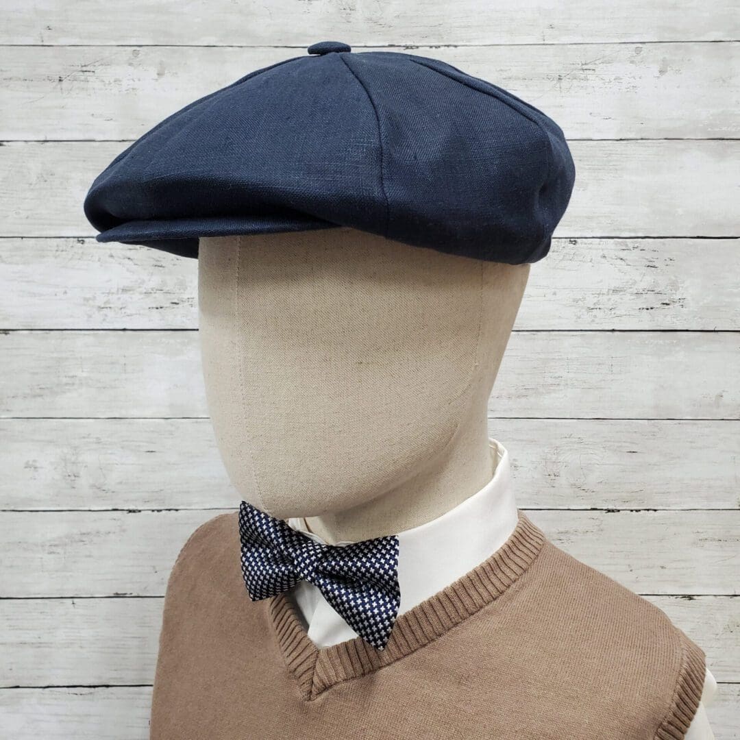 A mannequin wearing a bow tie and hat.