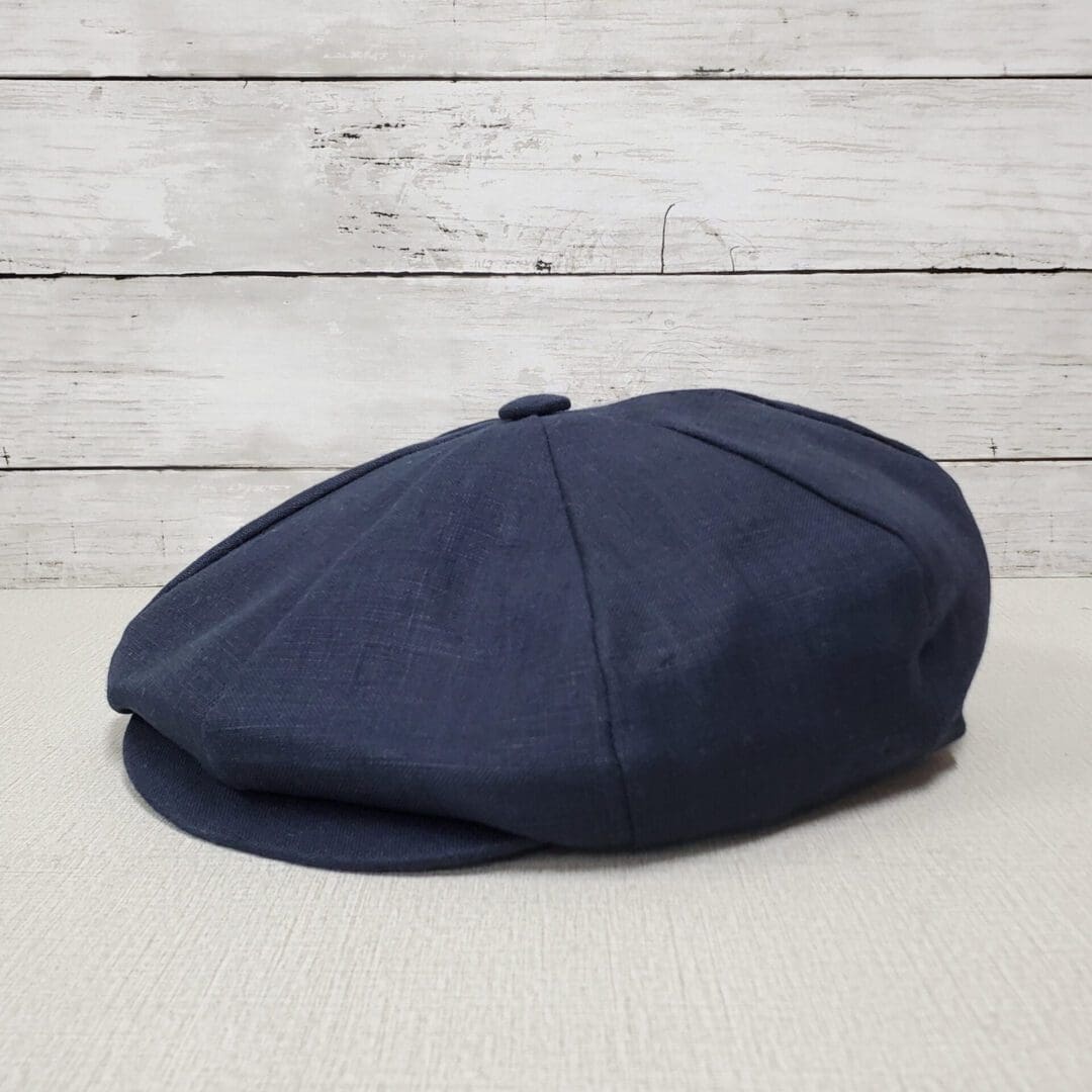 A blue hat is sitting on top of a table.