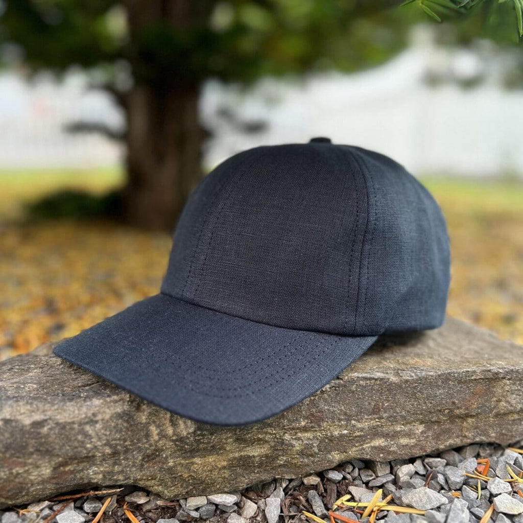 A black hat sitting on top of a rock.