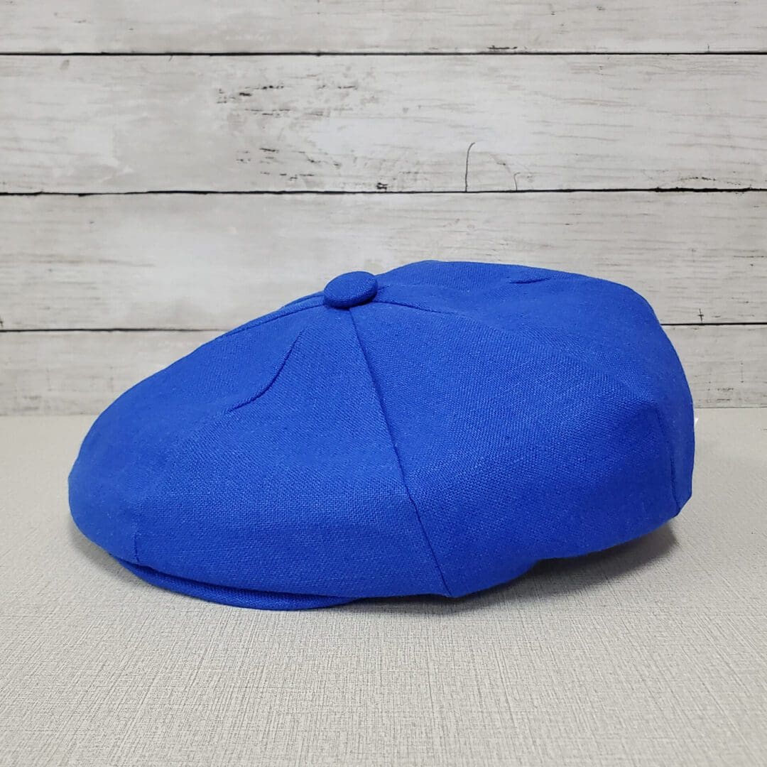A blue hat sitting on top of a table.