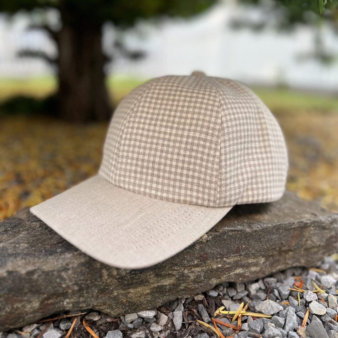 A hat is sitting on the ground outside.