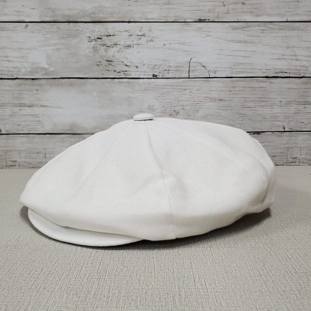 A white hat sitting on top of the floor.