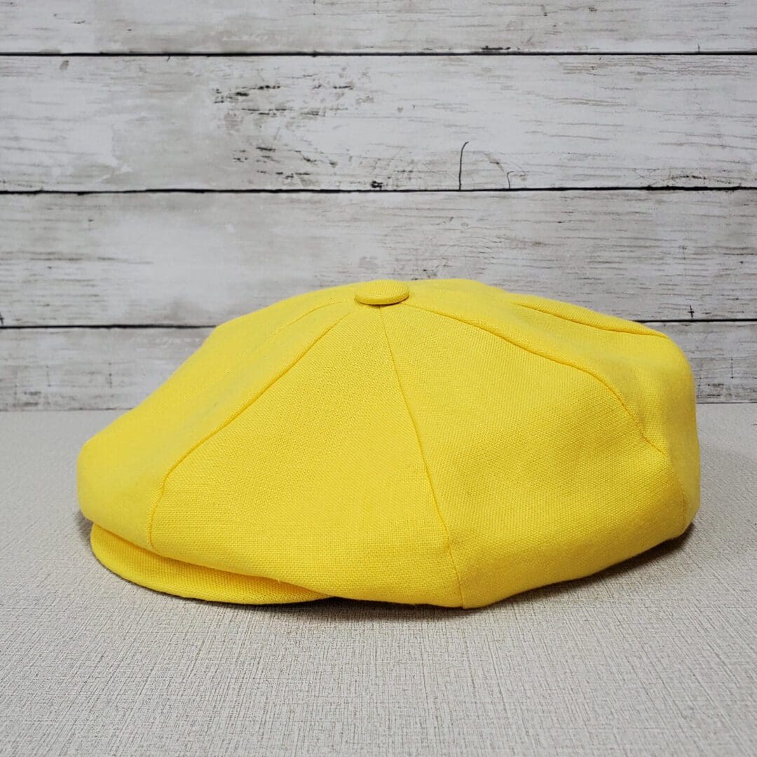 A yellow hat is sitting on the floor