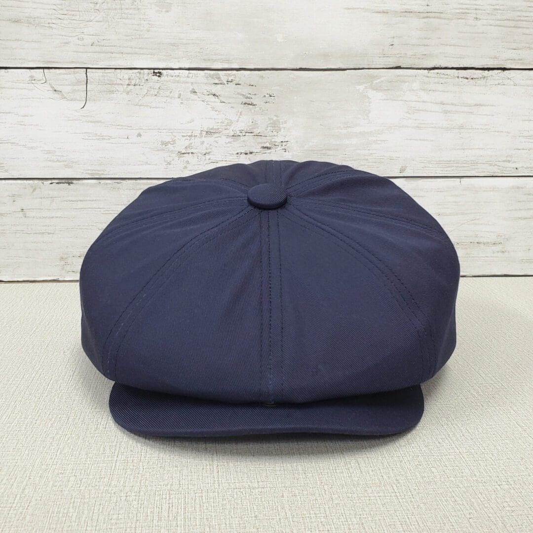 A blue hat is sitting on top of a table.