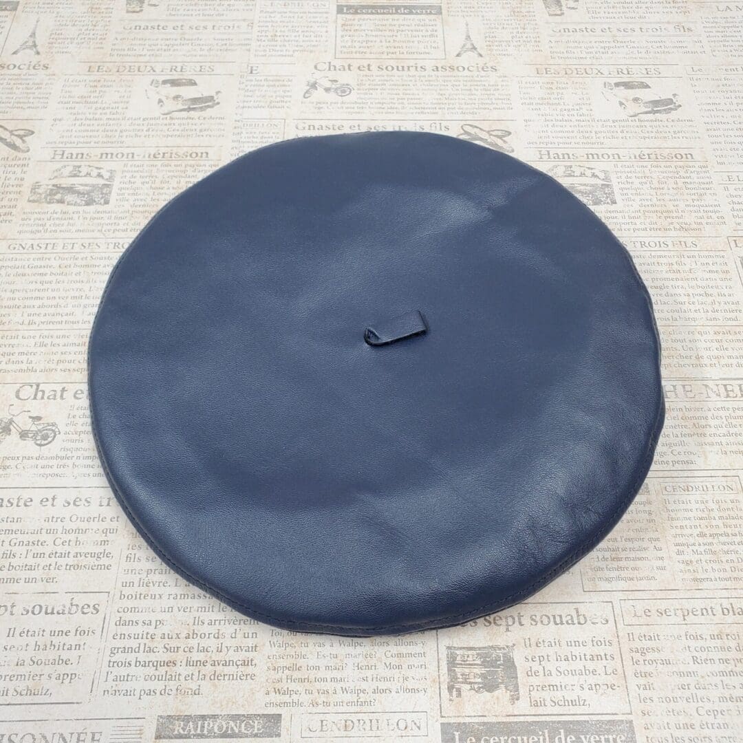 A black hat sitting on top of newspaper.