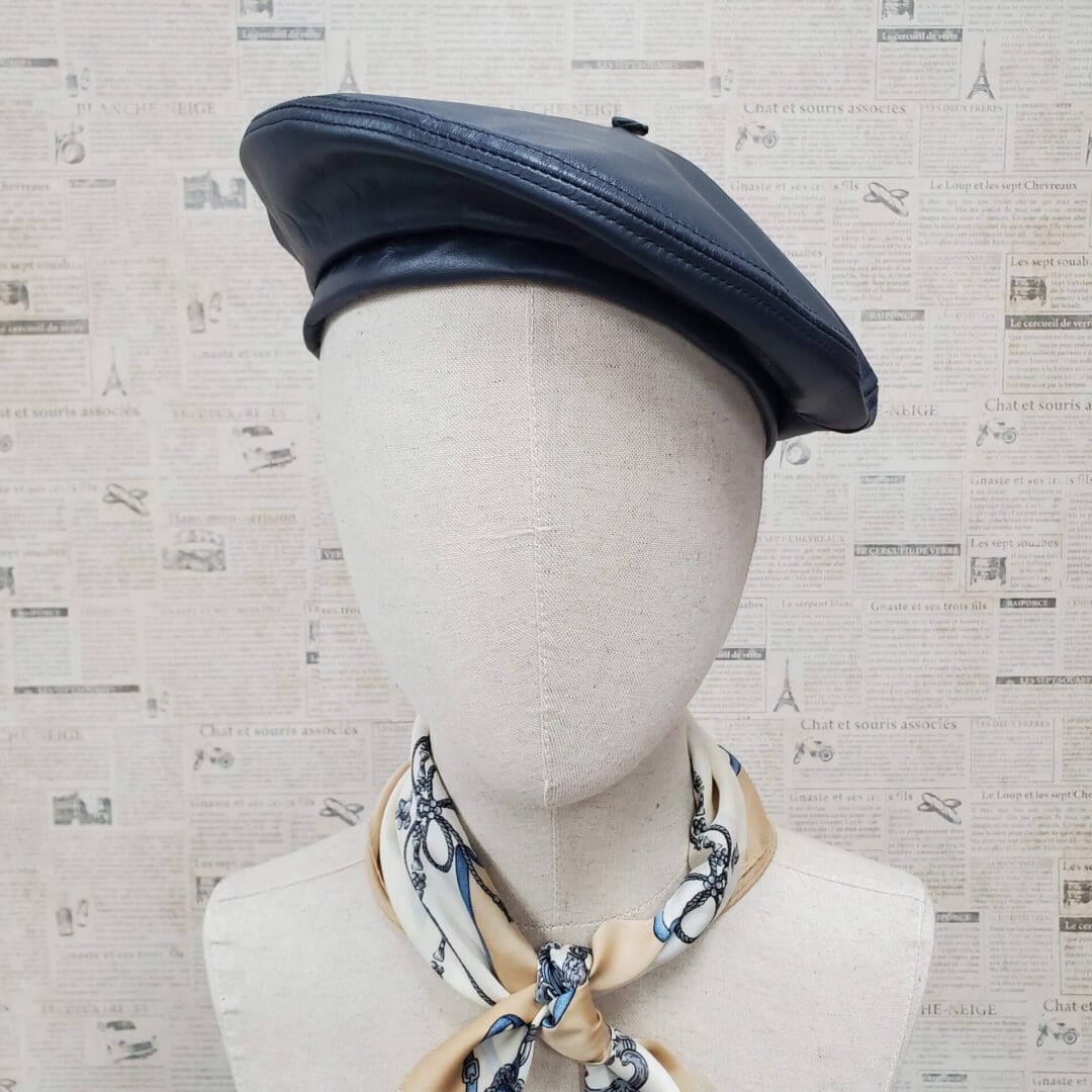 A mannequin wearing a hat and neck tie.