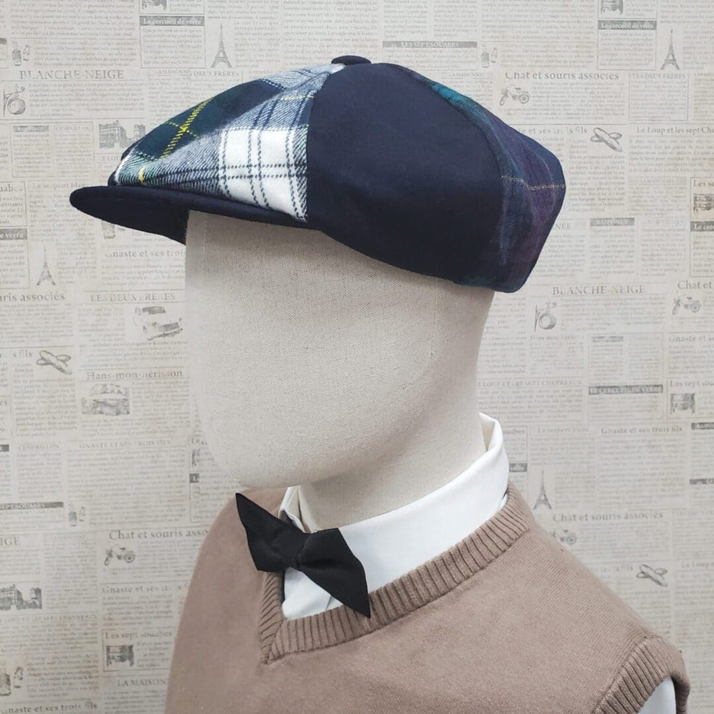 A mannequin wearing a hat and bow tie.