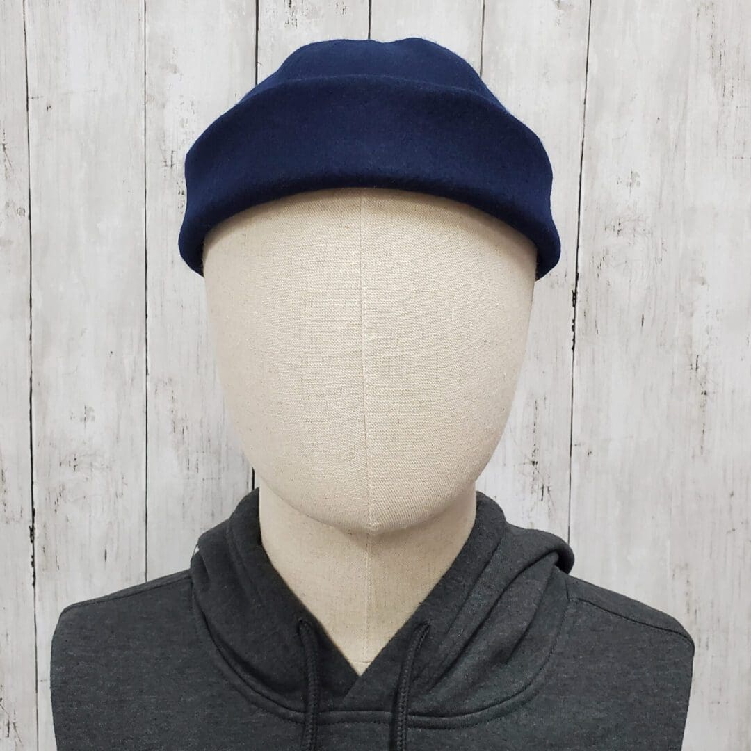 A mannequin wearing a blue hat and black sweatshirt.
