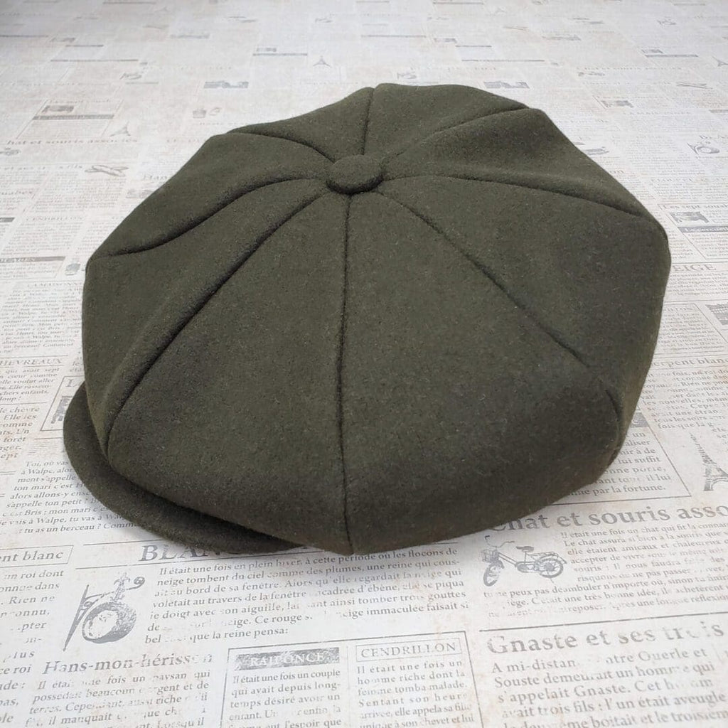 A green hat sitting on top of a table.
