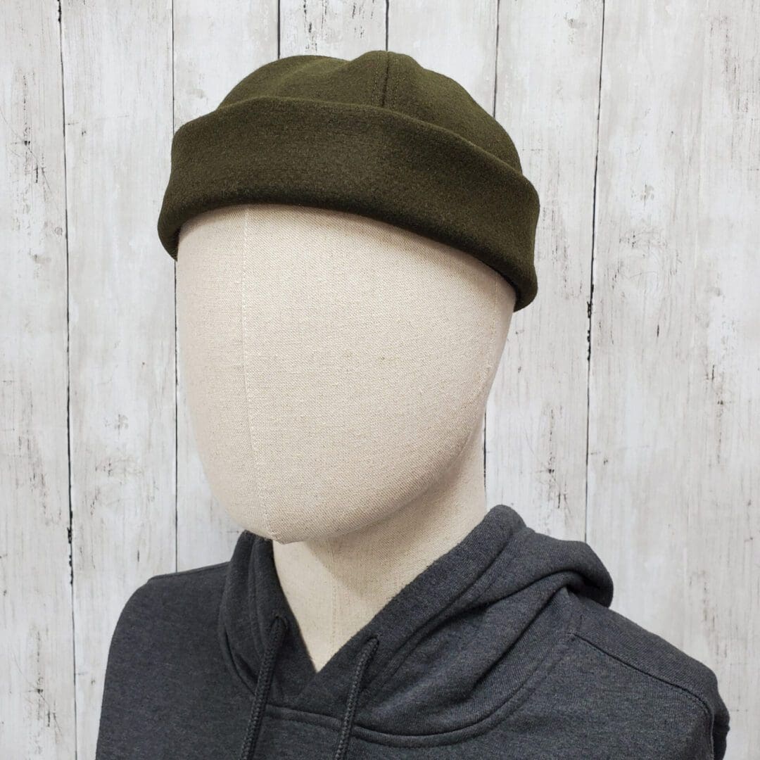 A mannequin wearing a hat and hoodie.
