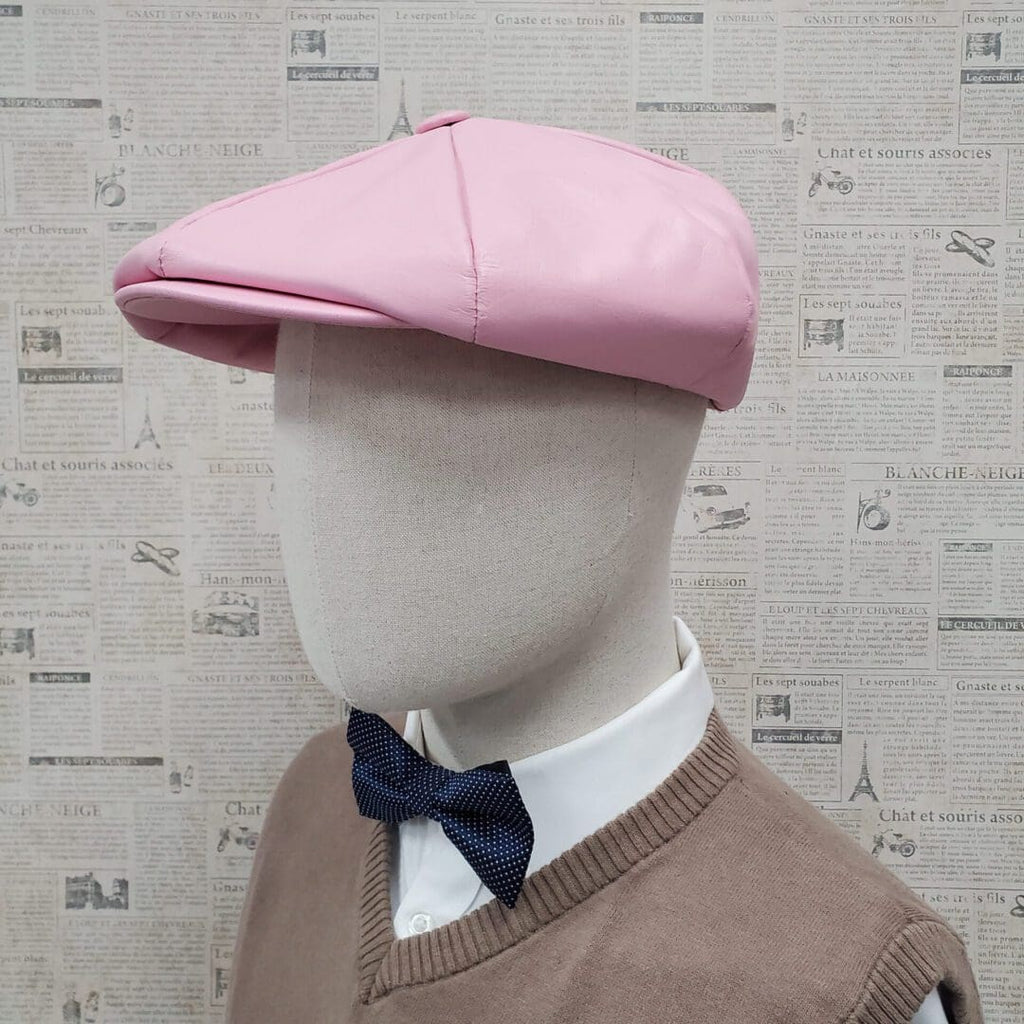 A mannequin wearing a pink hat and bow tie.