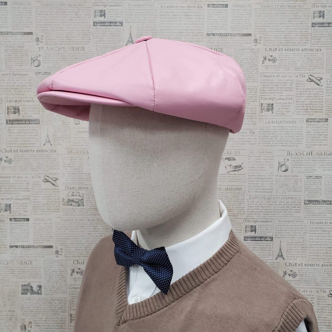 A mannequin wearing a pink hat and bow tie.