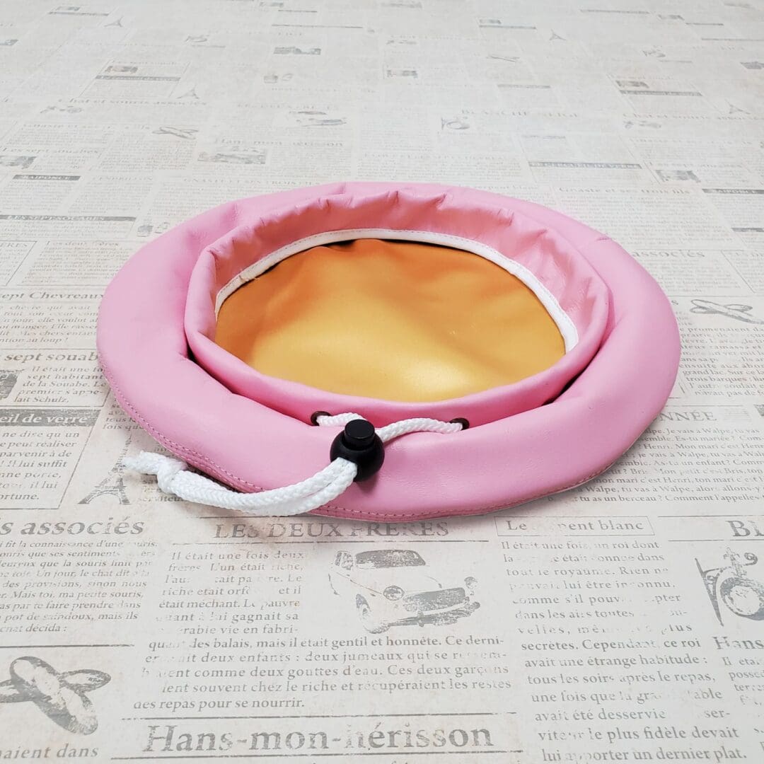 A pink bowl sitting on top of a table.