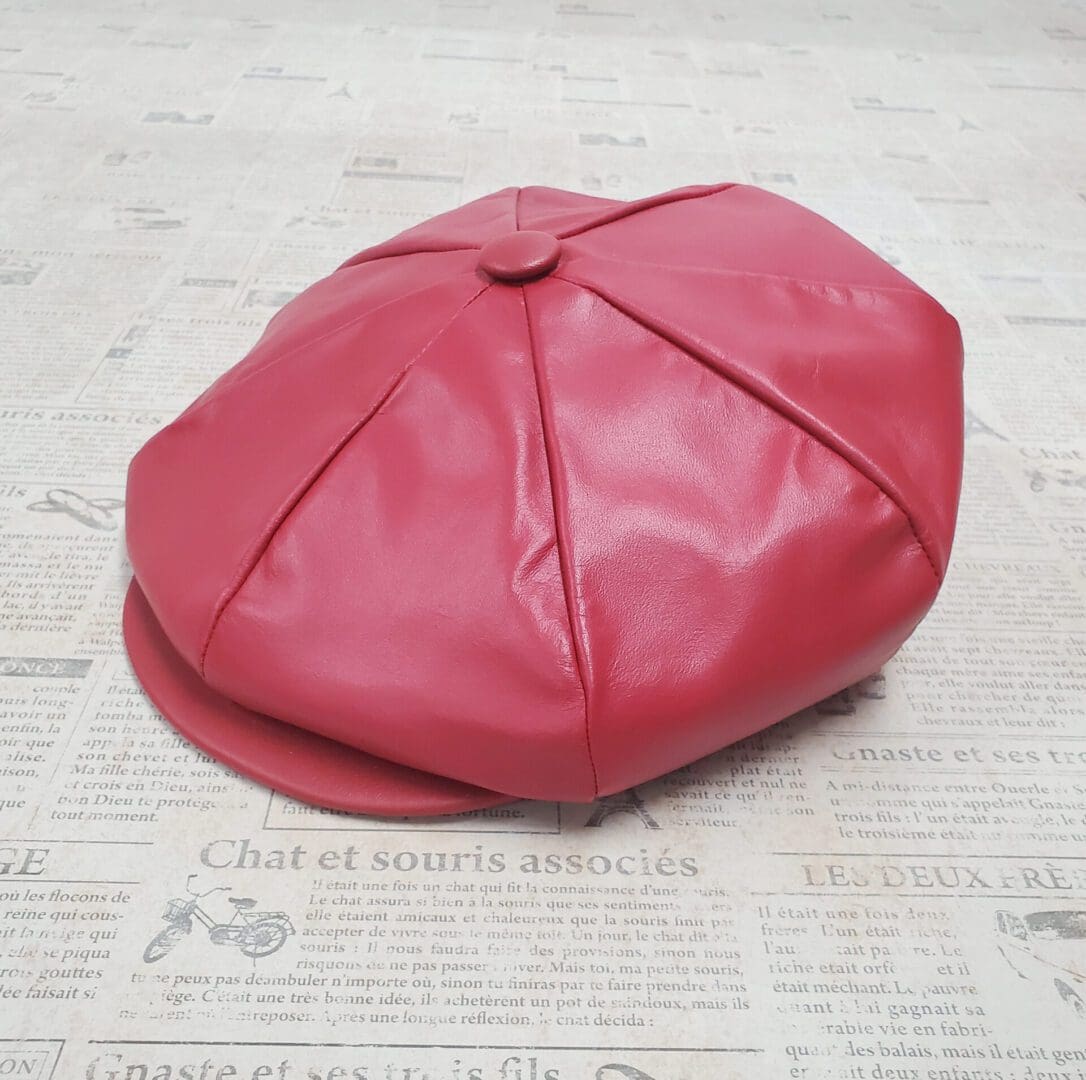 A red hat sitting on top of the floor.