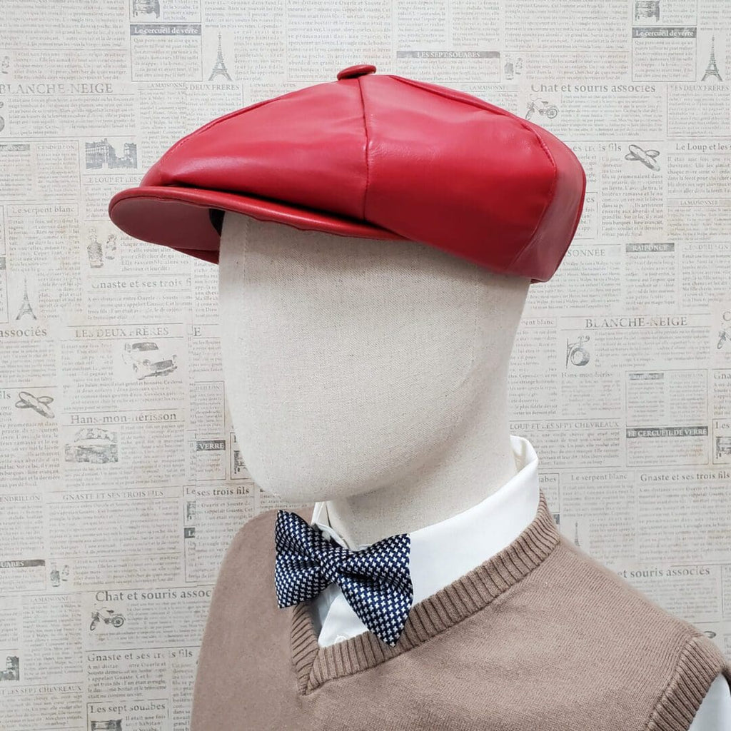 A mannequin wearing a red hat and bow tie.