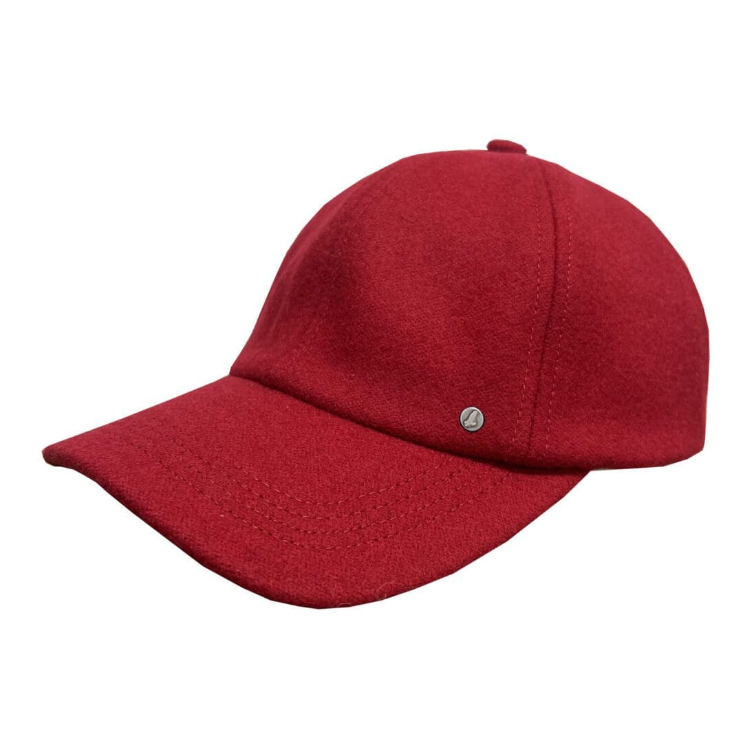 A red hat with a silver metal emblem on it's side.