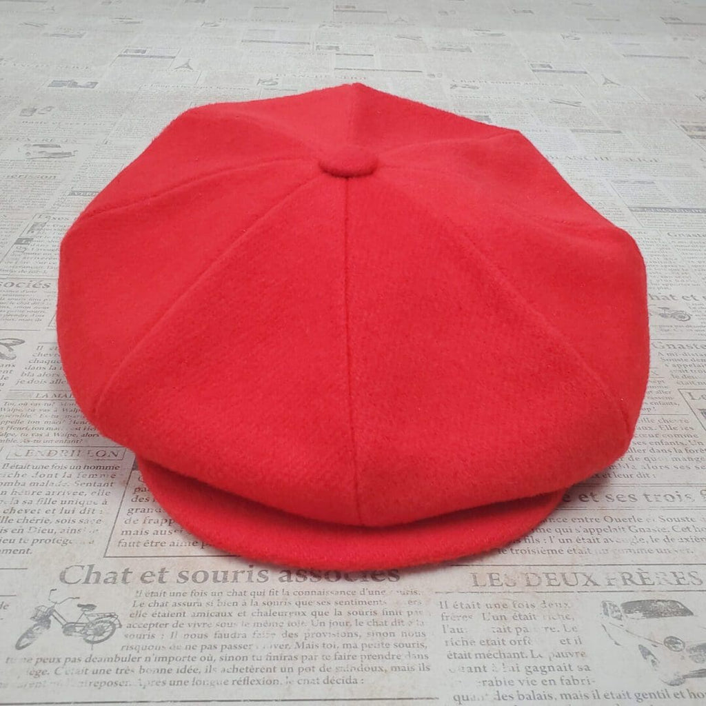 A red hat is sitting on top of the floor.