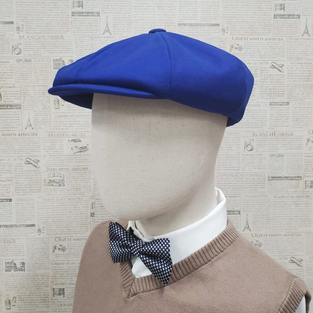 A mannequin wearing a blue hat and bow tie.