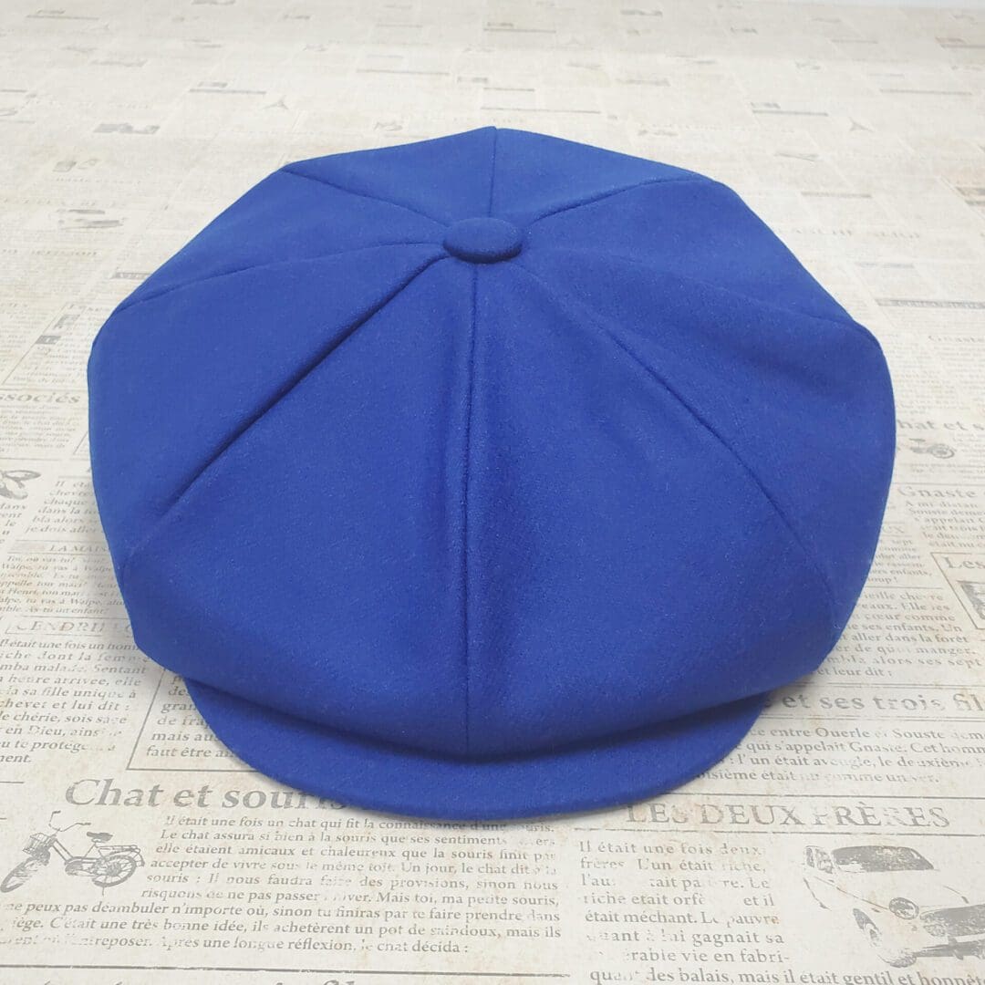 A blue hat is sitting on the floor.
