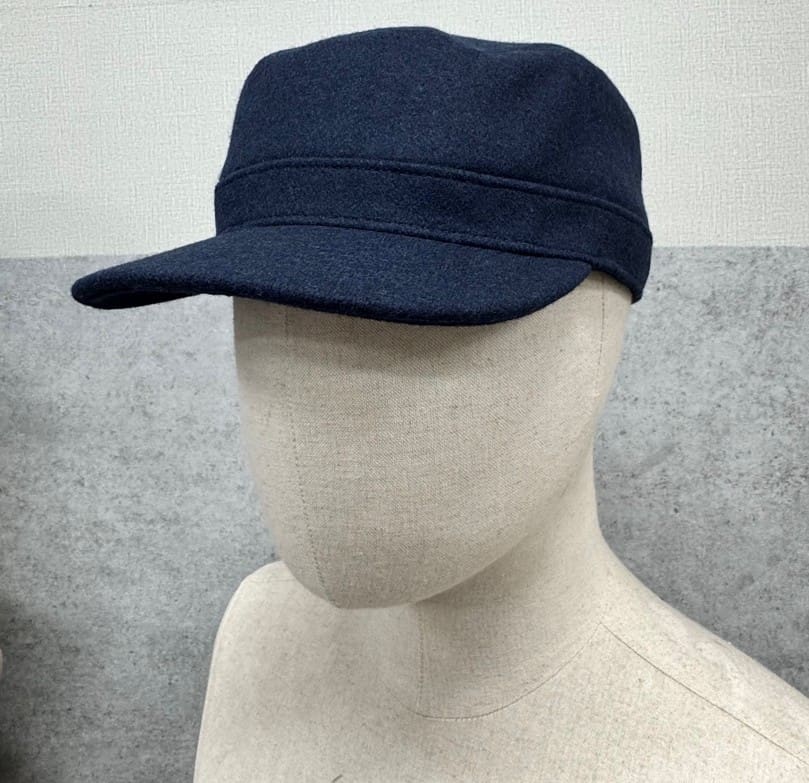 Mannequin wearing a dark blue cap.