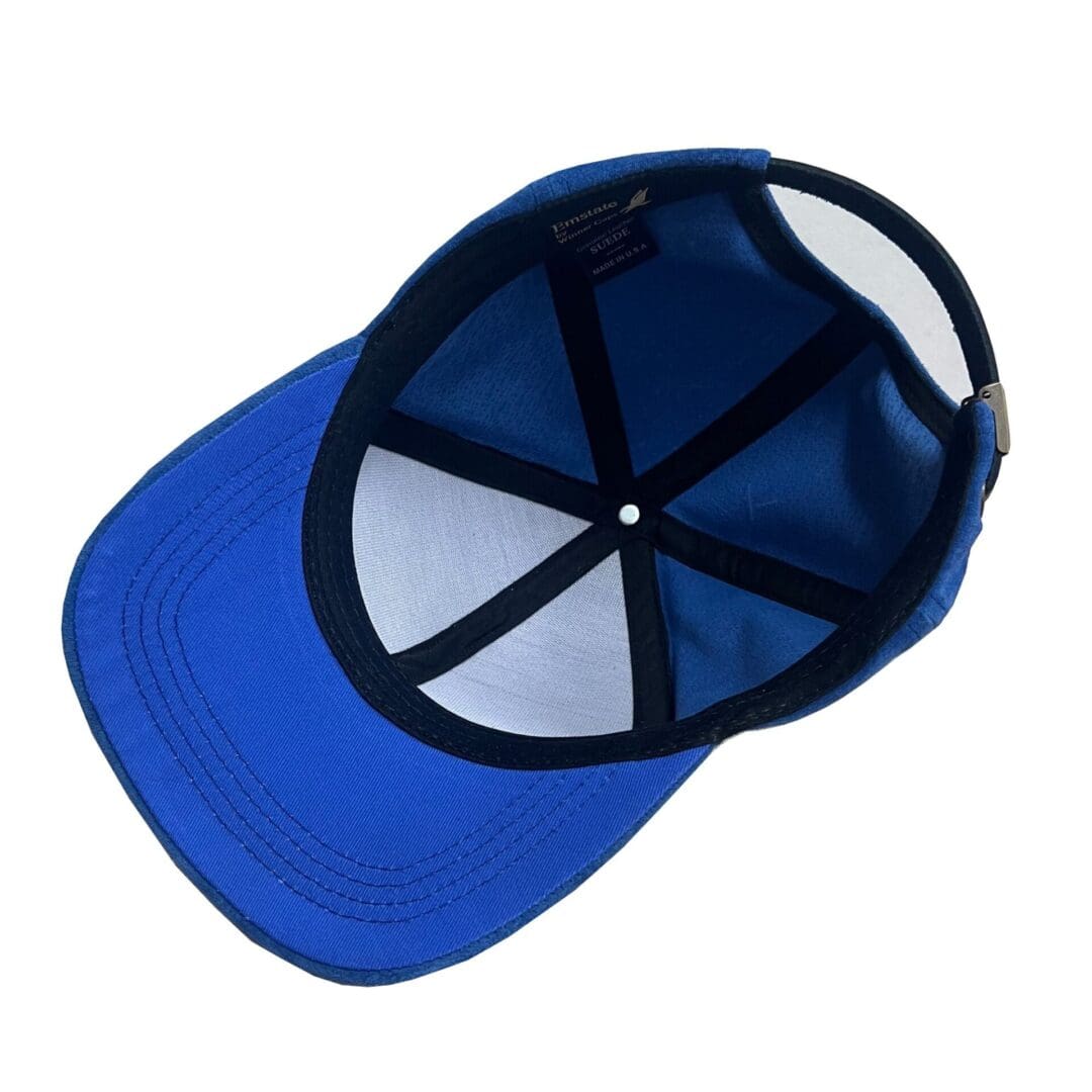 A blue hat with a black and white logo on it