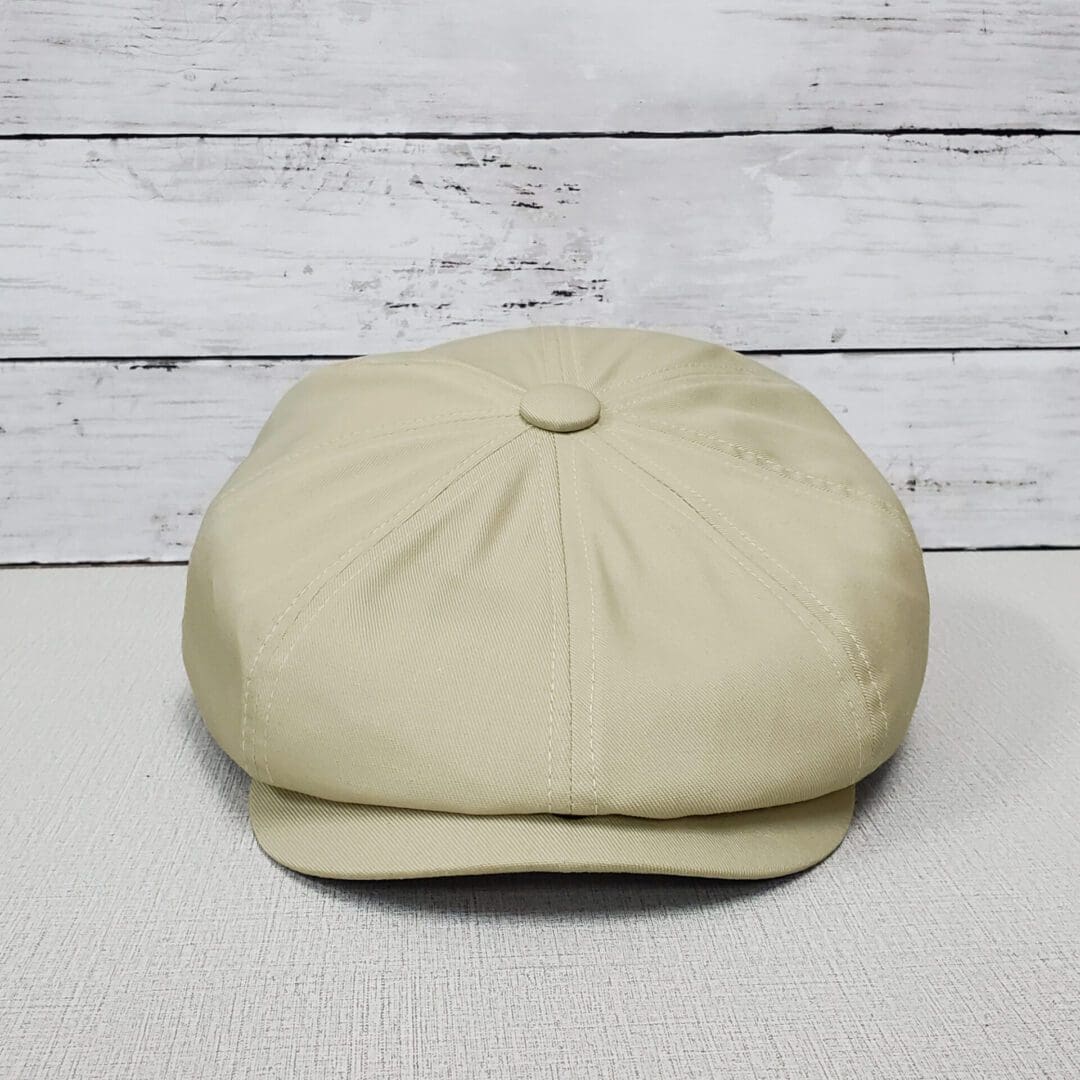 A beige hat sitting on top of a table.