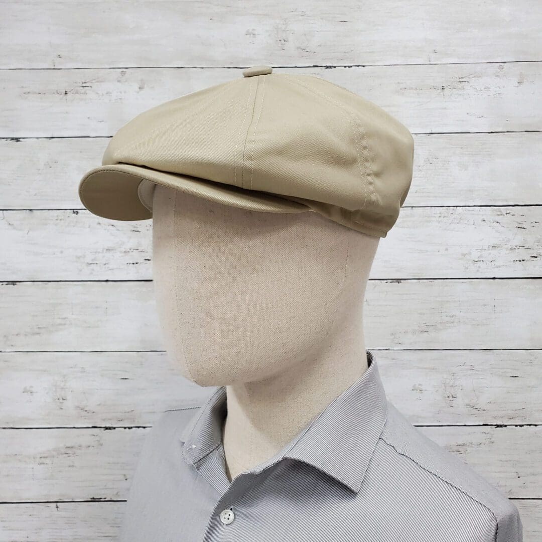 A man wearing a tan hat and gray shirt.