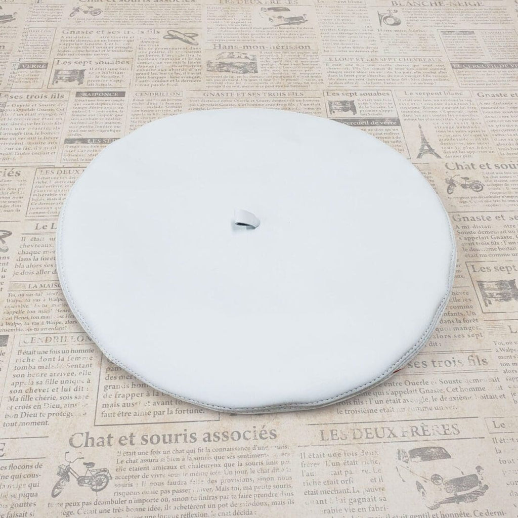 A white plate sitting on top of a newspaper.
