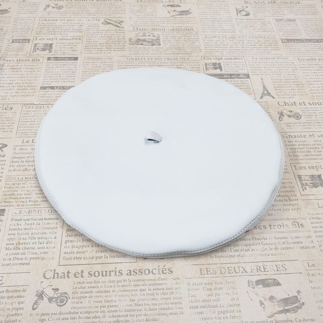 A white plate sitting on top of a newspaper.