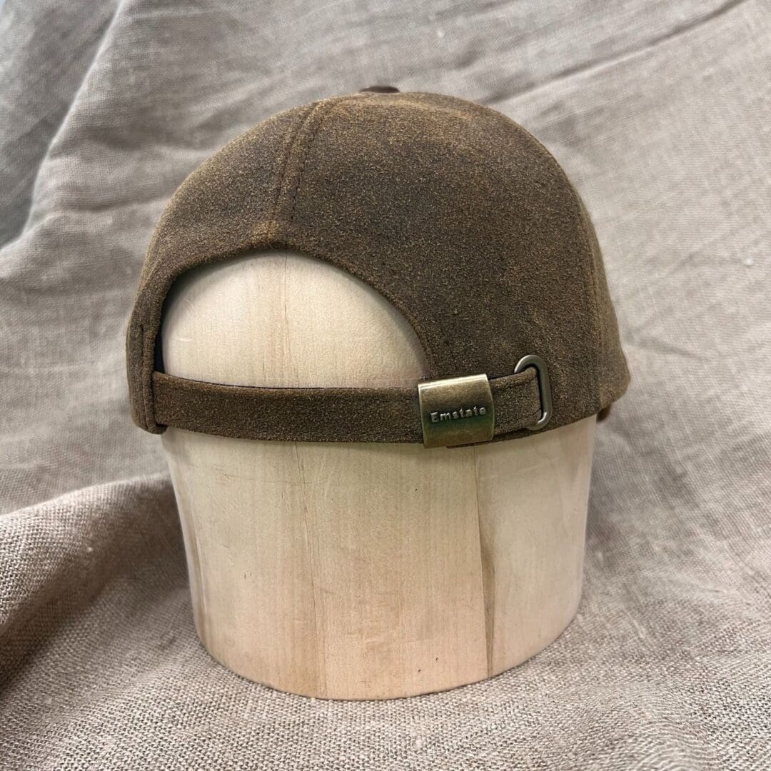 A hat is sitting on top of a wooden bowl.